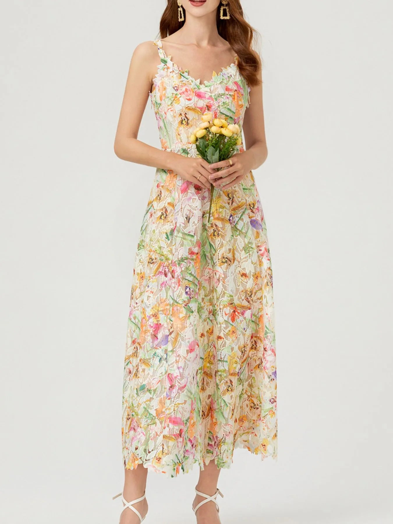 NEWYORKLISTED STYLE COLLECTION: Woman wearing a floral dress holding flowers on a white background