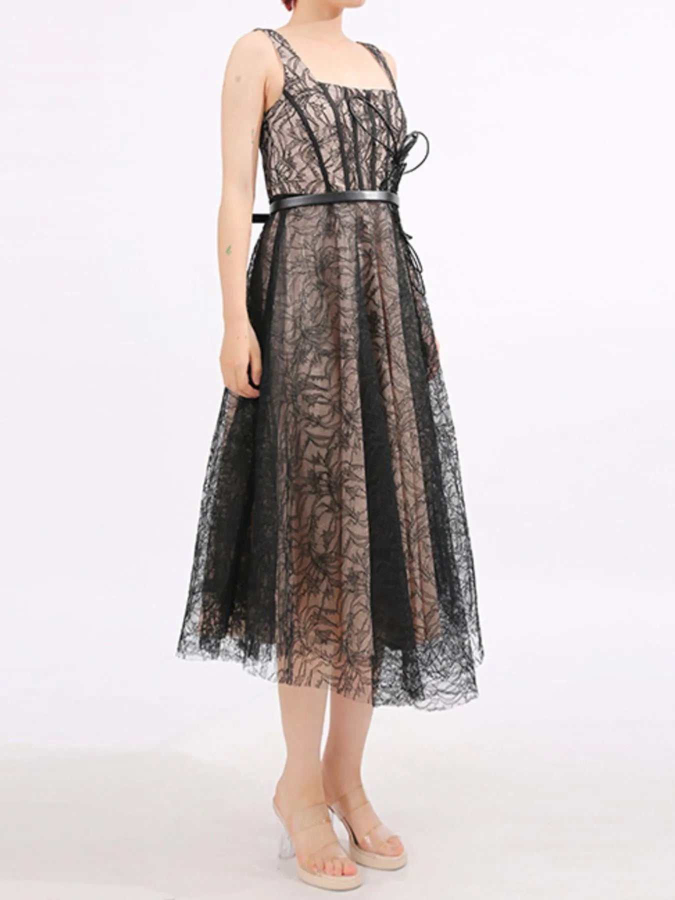 NEWYORKLISTED RUNWAY STYLE: Black lace dress worn by a model on a white background