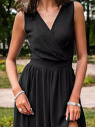 NEWYORKLISTED STYLE COLLECTION: Person wearing a black dress with a blurred outdoor background