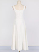 NEWYORKLISTED STYLE COLLECTION: White sleeveless dress on a mannequin against a white background