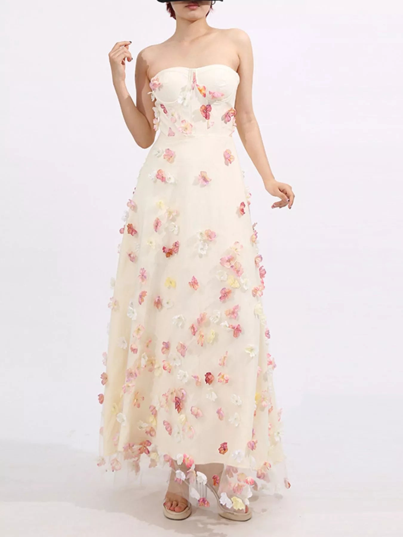 NEWYORKLISTED STYLE COLLECTION: White strapless gown with floral embellishments on a white background