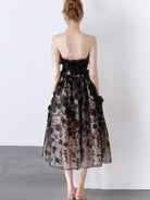 NEWYORKLISTED STYLE COLLECTION: Woman wearing a floral dress with a plain background