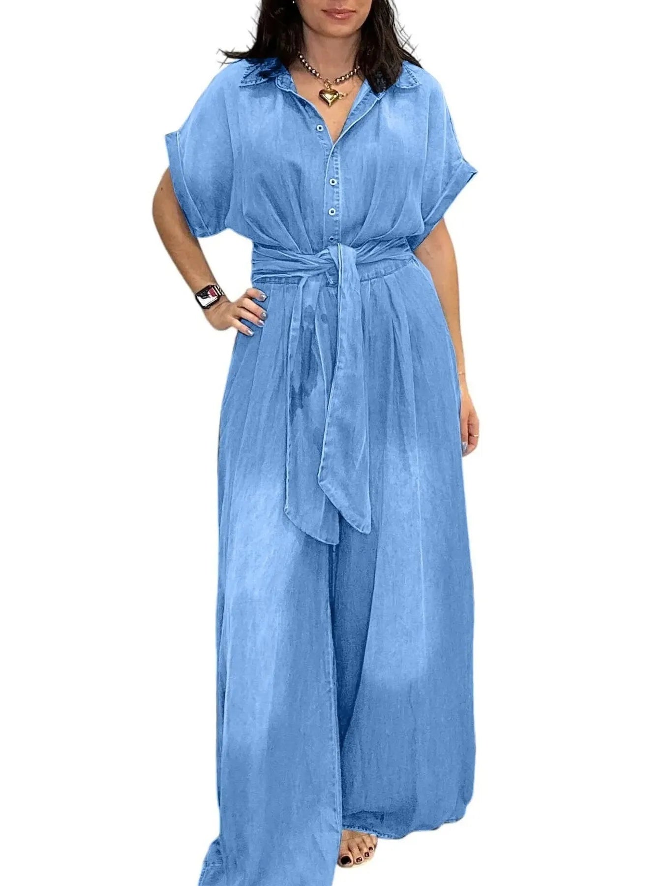 NEWYORKLISTED STYLE COLLECTION: Woman wearing a blue denim jumpsuit on a white background