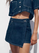 NEWYORKLISTED STYLE COLLECTION: Person wearing a blue denim skirt and jacket on a white background