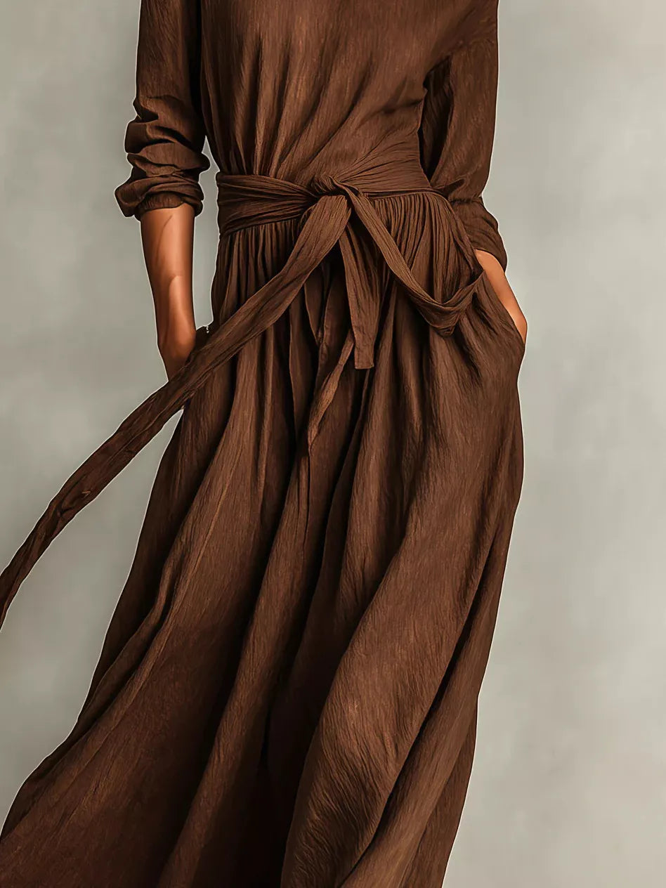 NEWYORKLISTED STYLE COLLECTION: Brown dress with a tie waist on a neutral background