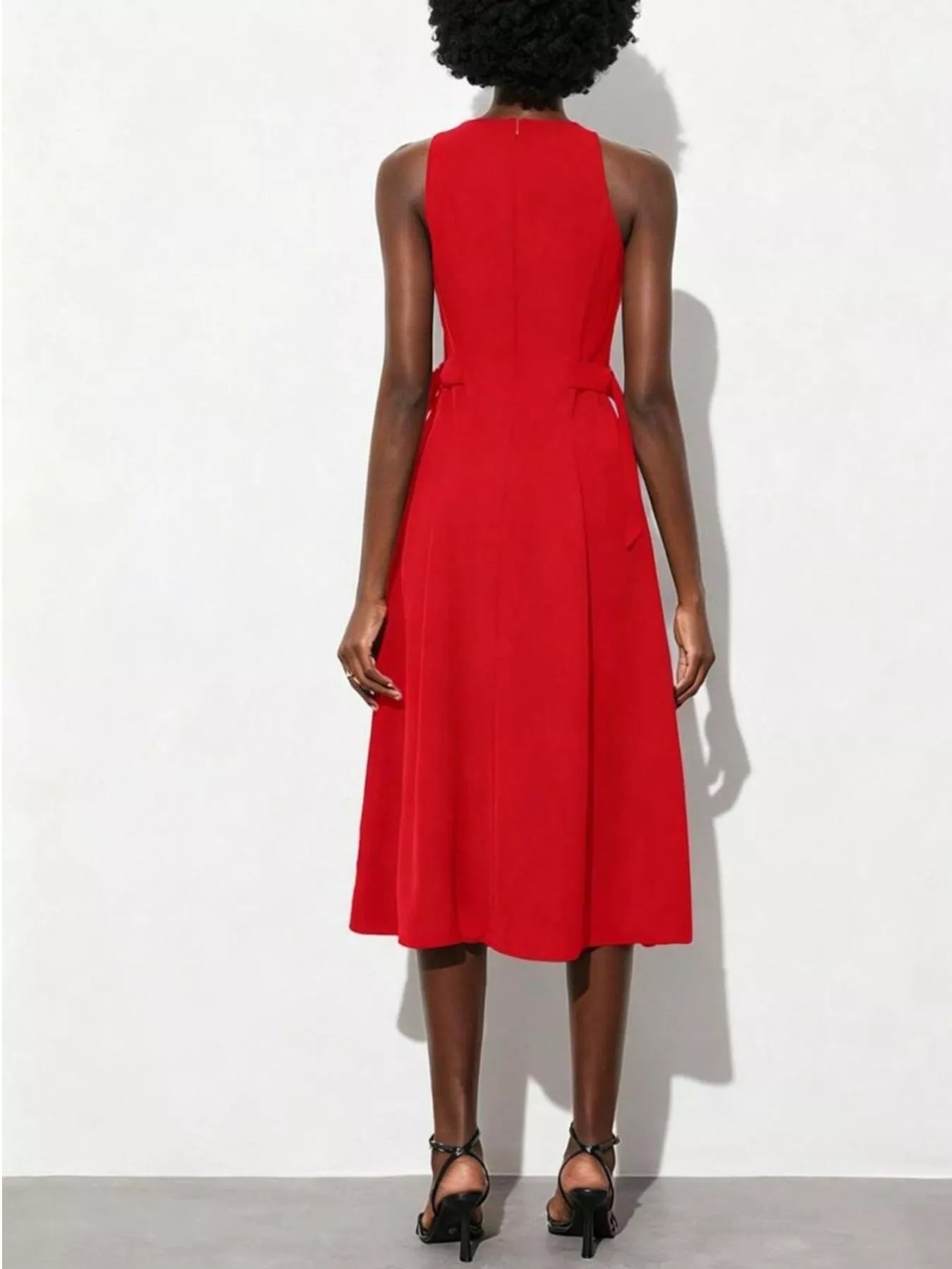 NEWYORKLISTED STYLE COLLECTION: Red dress worn by a person on a white background