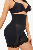 NEWYORKLISTED Intimate Apparel: Black shapewear garment on a model against a white background