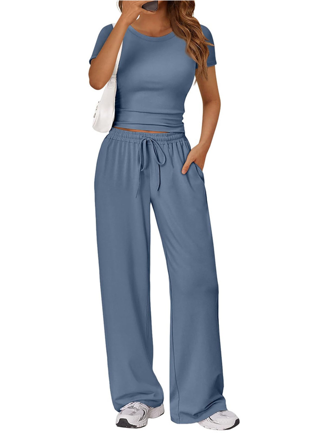 NEWYORKLISTED COMFORT COLLECTION: Woman wearing a blue outfit with wide-leg pants and a matching top on a white background