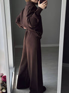 NEWYORKLISTED Comfort Collection: Person wearing a brown outfit standing in front of a mirror.