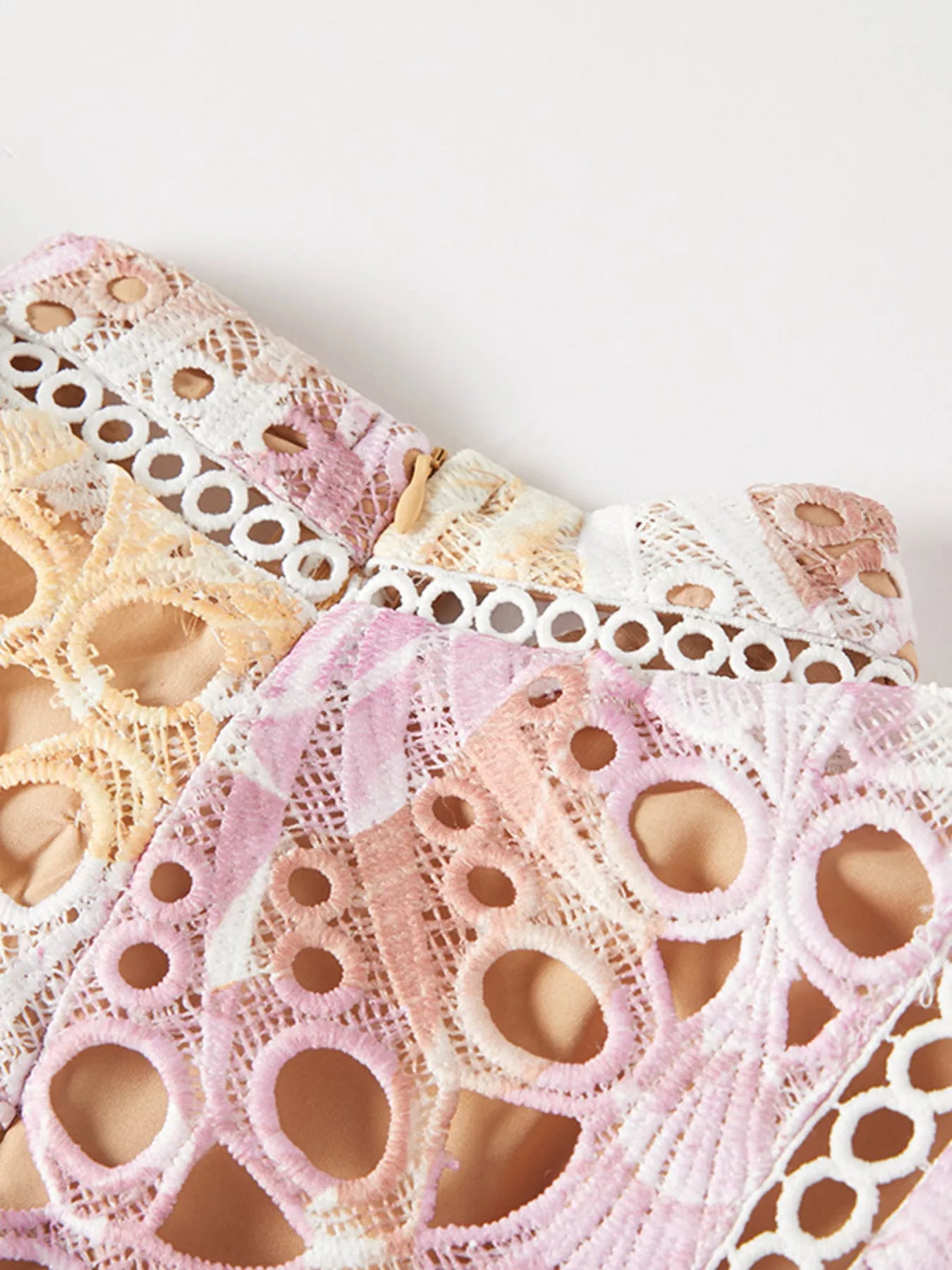 NEWYORKLISTED STYLE COLLECTION: Close-up of lace fabric with a white background