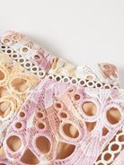 NEWYORKLISTED STYLE COLLECTION: Close-up of lace fabric with a white background