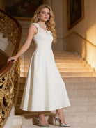 NEWYORKLISTED STYLE COLLECTION: Woman in a white dress standing on a staircase with ornate railings.