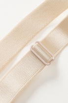 NEWYORKLISTED Intimate Apparel: Beige belt with a plastic buckle on a light gray background