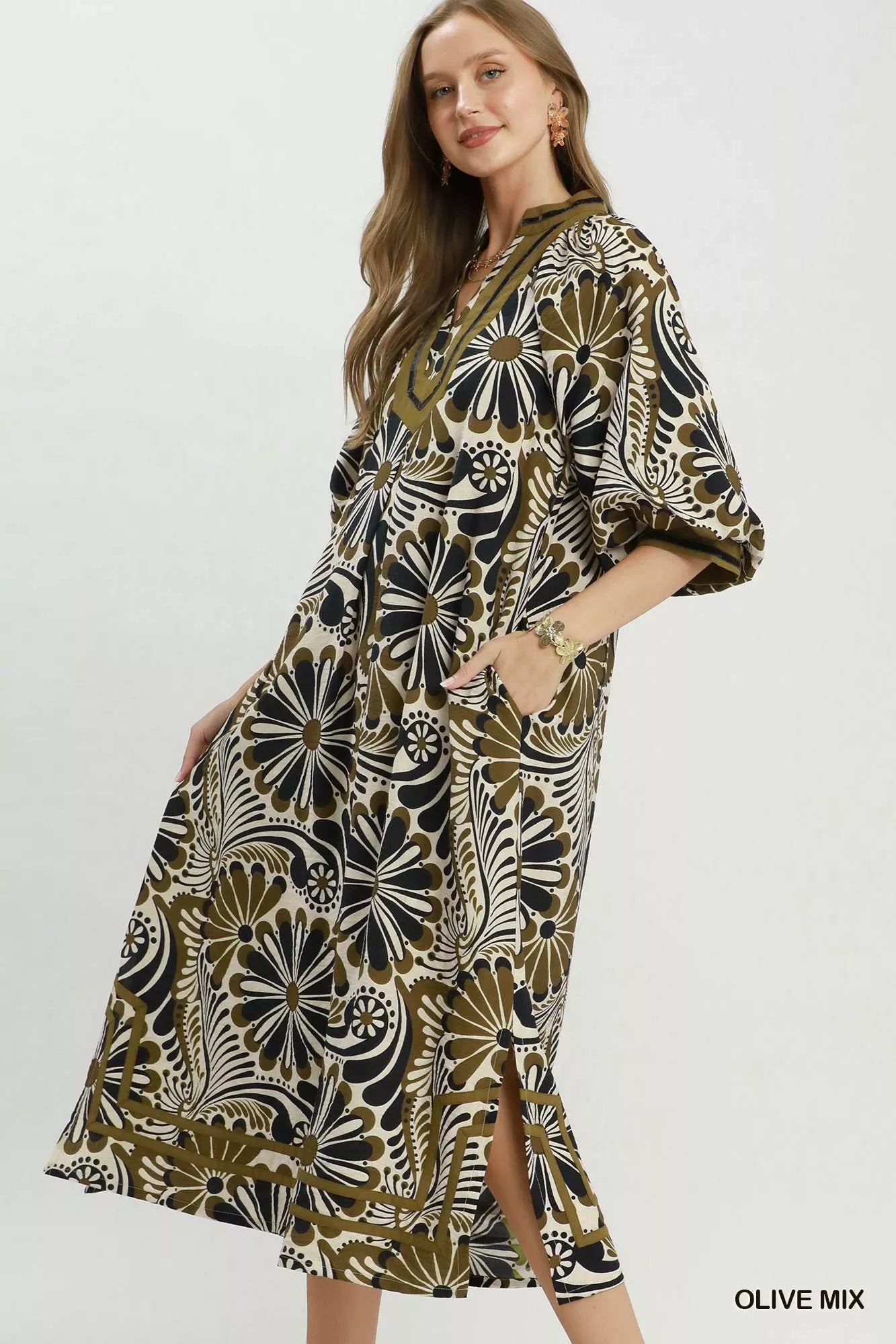 NEWYORKLISTED STYLE COLLECTION: Woman wearing a patterned dress with a white background