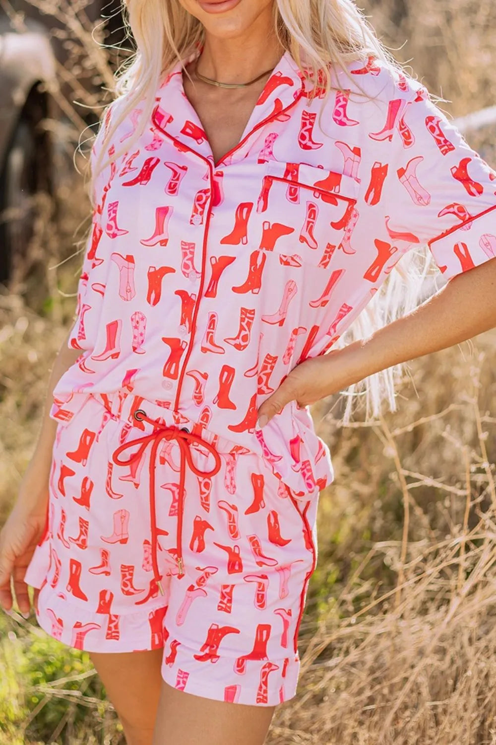 NEWYORKLISTED Intimate Apparel: Woman wearing a pink outfit with red boot pattern in a natural setting