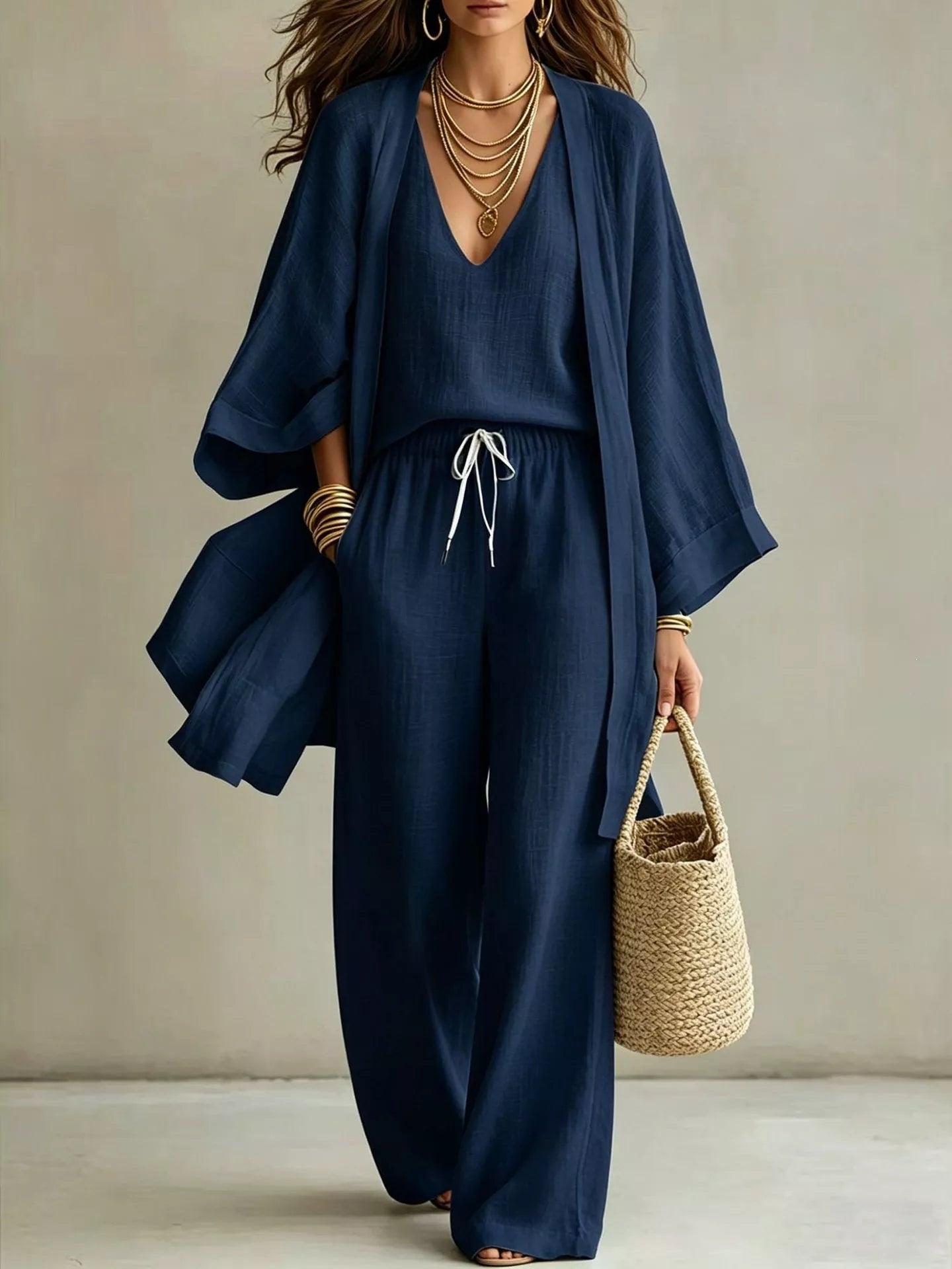 NEWYORKLISTED STYLE COLLECTION: Woman wearing a navy blue outfit with a beige background