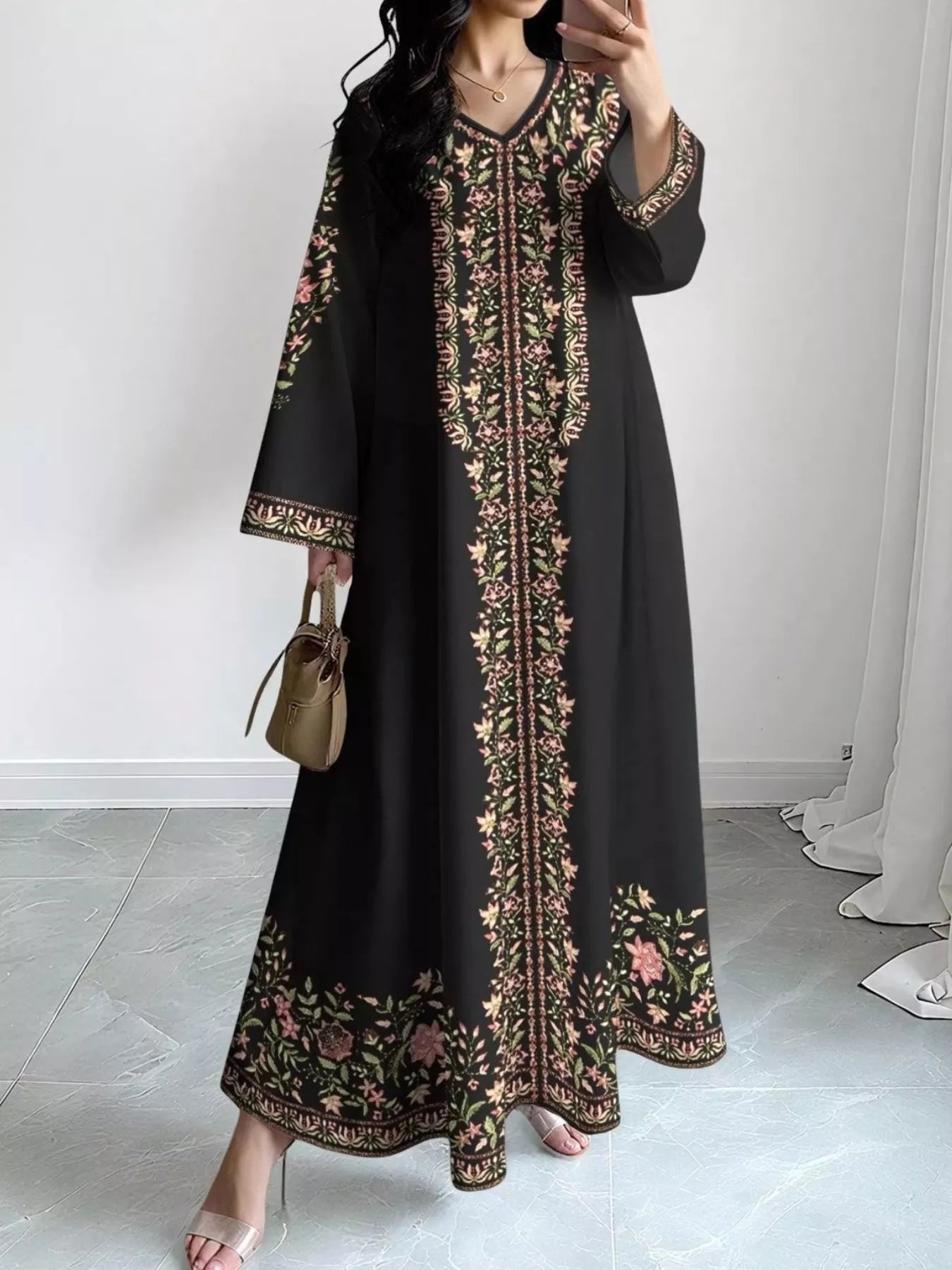 NEWYORKLISTED STYLE COLLECTION: Woman wearing a black dress with floral embroidery in a minimal indoor setting