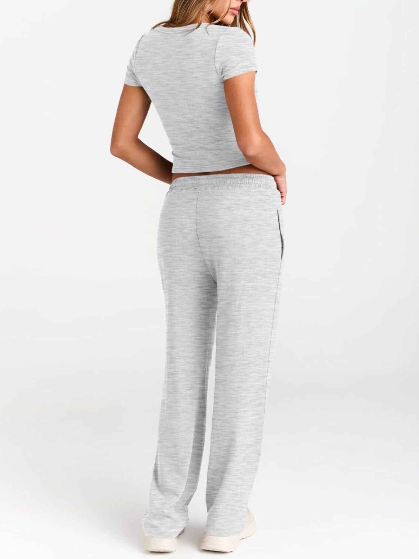 NEWYORKLISTED COMFORT COLLECTION: Woman wearing a gray striped outfit on a white background