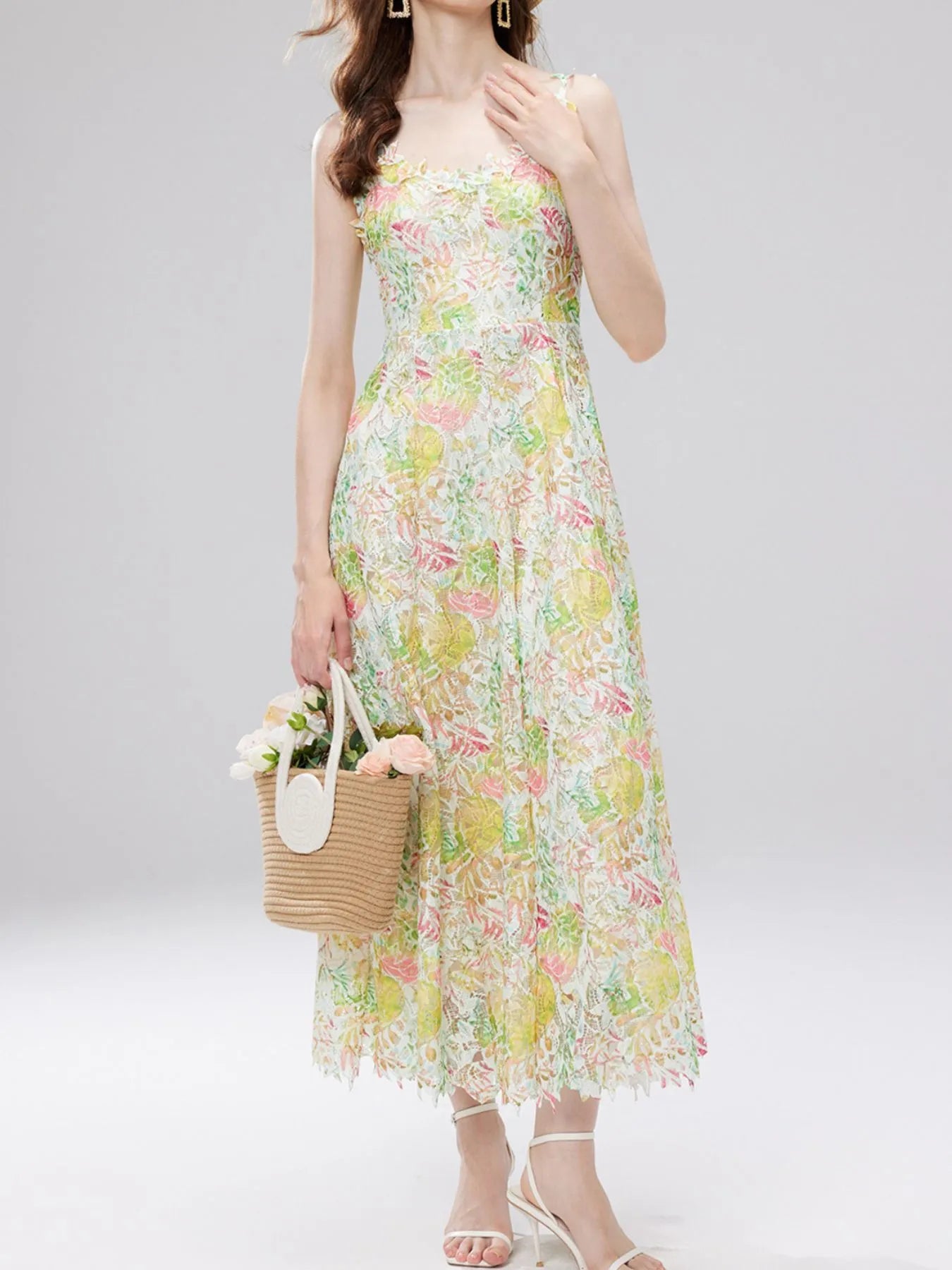 NEWYORKLISTED STYLE COLLECTION: Woman wearing a floral dress holding a straw bag with flowers on a white background