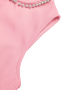 NEWYORKLISTED STYLE COLLECTION: Pink swimsuit with pearl details on a white background
