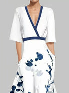 NEWYORKLISTED STYLE COLLECTION: White dress with blue floral pattern and neckline on a gray background