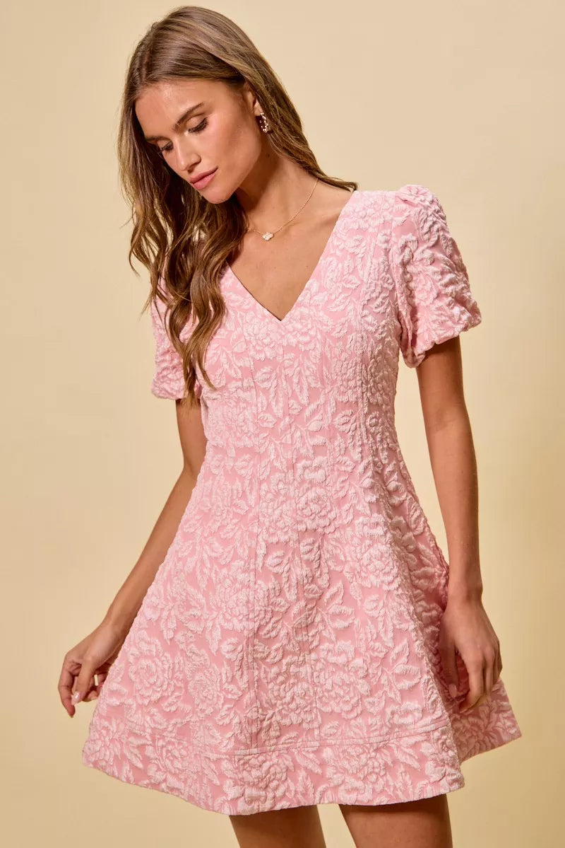 NEWYORKLISTED STYLE COLLECTION: Female model wearing a pink floral dress against a beige background