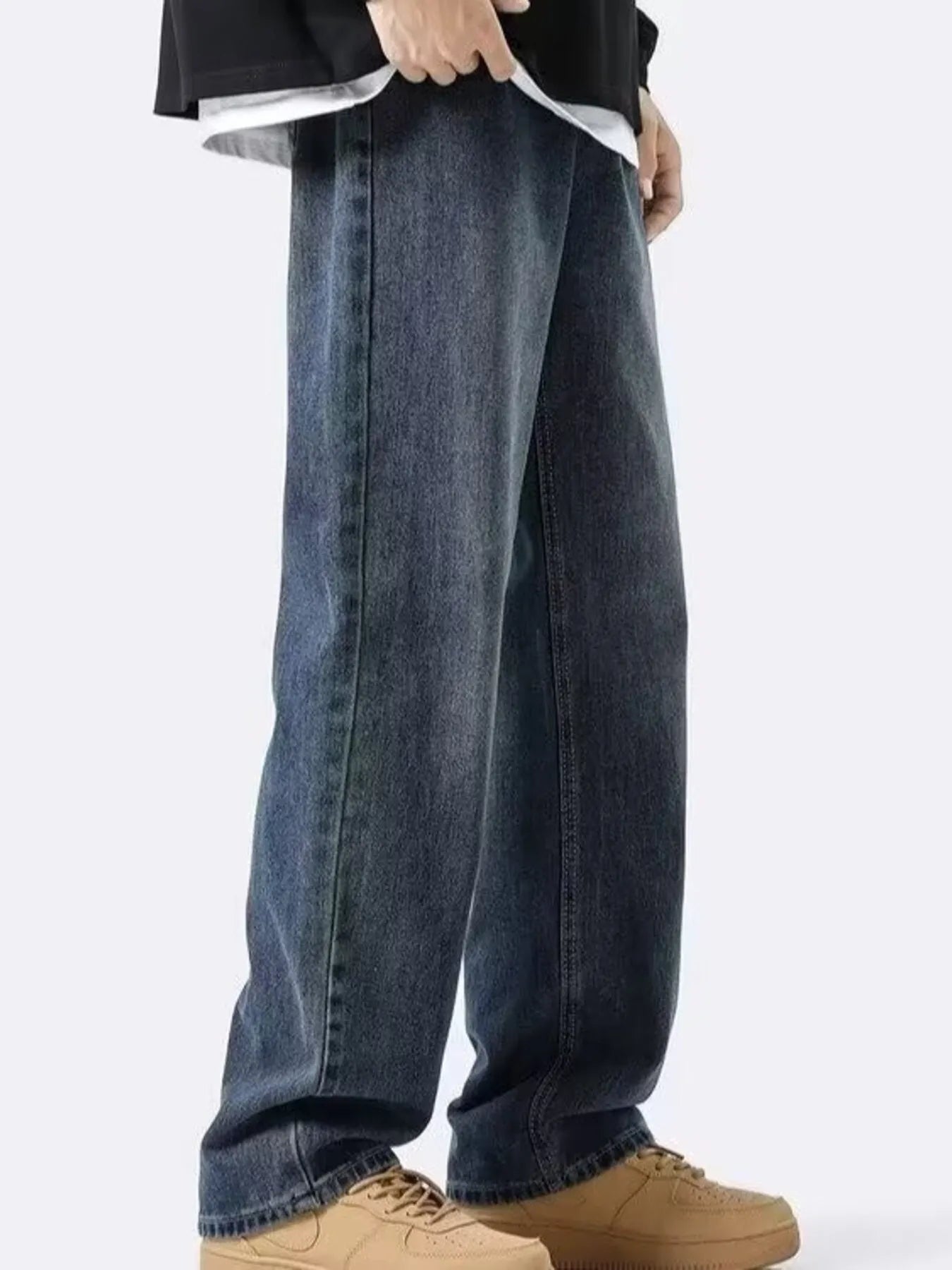 NEWYORKLISTED ATLAS MEN's COLLECTION: Person wearing blue jeans and brown shoes on a white background