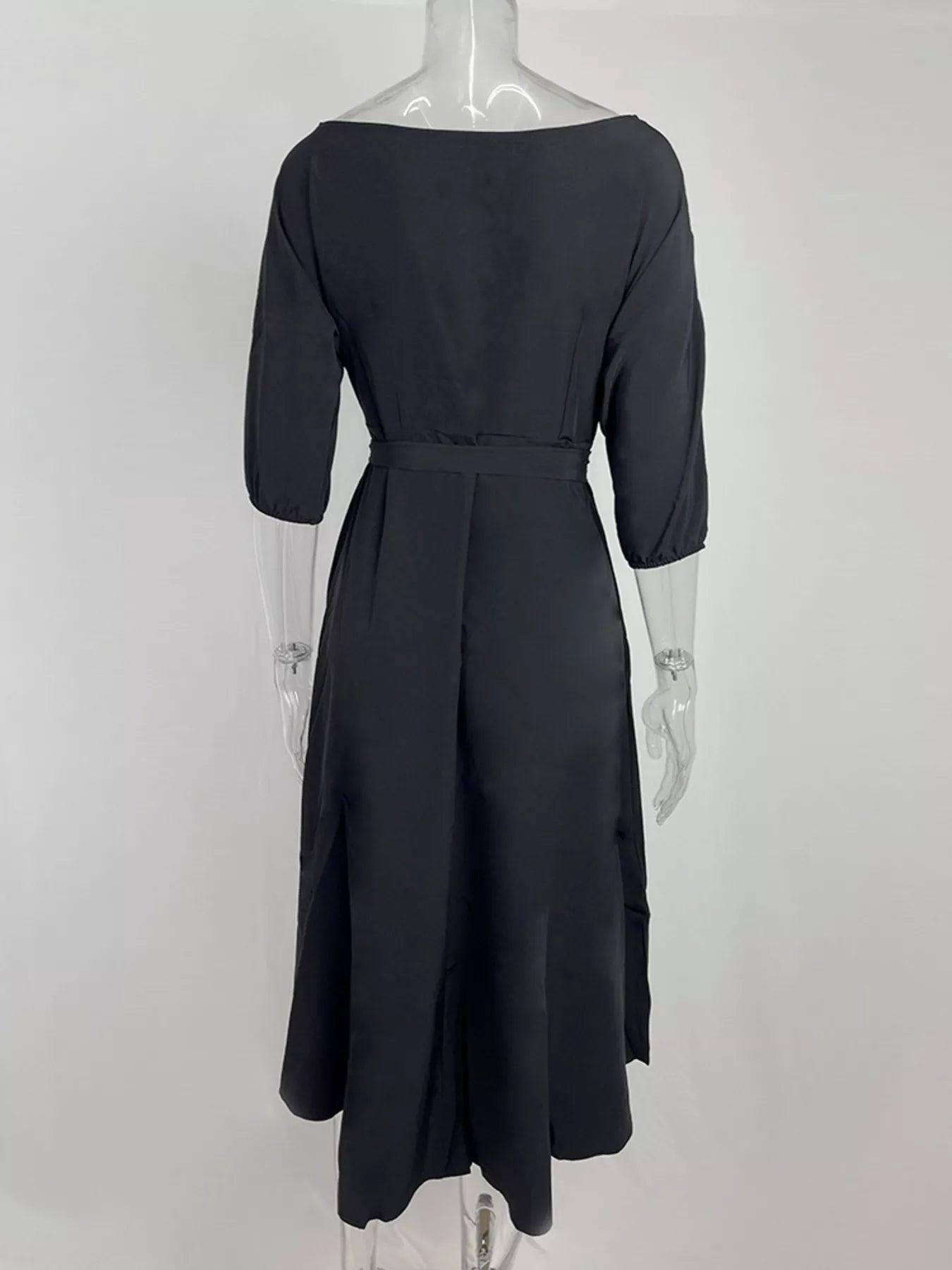NEWYORKLISTED STYLE COLLECTION: Black dress on a mannequin against a white background