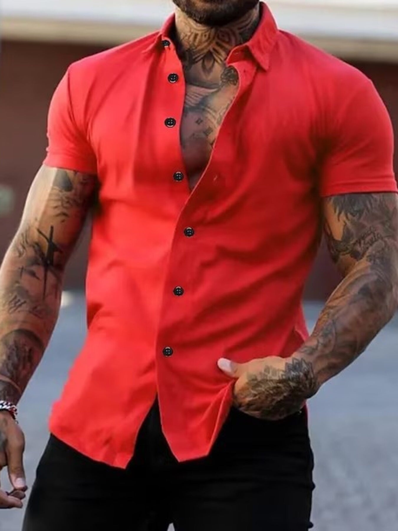 NEWYORKLISTED ATLAS MEN's COLLECTION: Man wearing a red button-up shirt with tattoos on arms and chest.