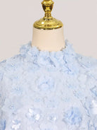 NEWYORKLISTED STYLE COLLECTION: Light blue floral dress on a mannequin with a white background