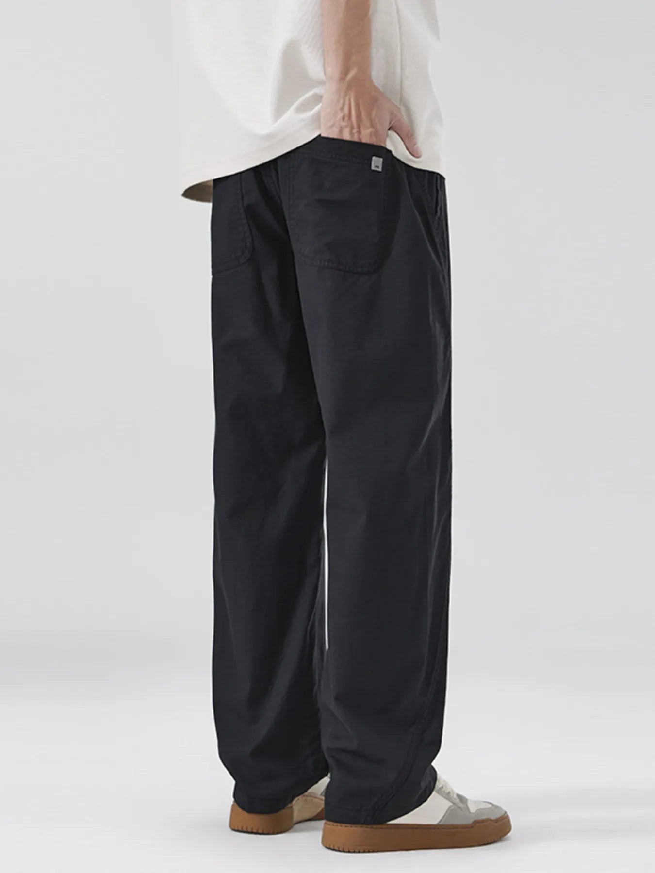 NEWYORKLISTED ATLAS MEN's COLLECTION: Person wearing black pants on a white background