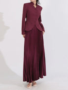 NEWYORKLISTED STYLE COLLECTION: Maroon suit with a jacket and pleated skirt on a white background