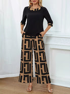 NEWYORKLISTED STYLE COLLECTION: Woman wearing a black top and tan colored patterned pants standing against a white wall.