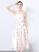 NEWYORKLISTED STYLE COLLECTION: Woman wearing a strapless floral dress against a white background