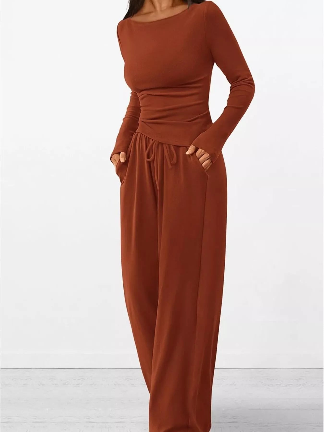 Brown jumpsuit with long sleeves on a white background
