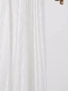 NEWYORKLISTED STYLE COLLECTION: Close-up of white fabric with a subtle pattern on a light background