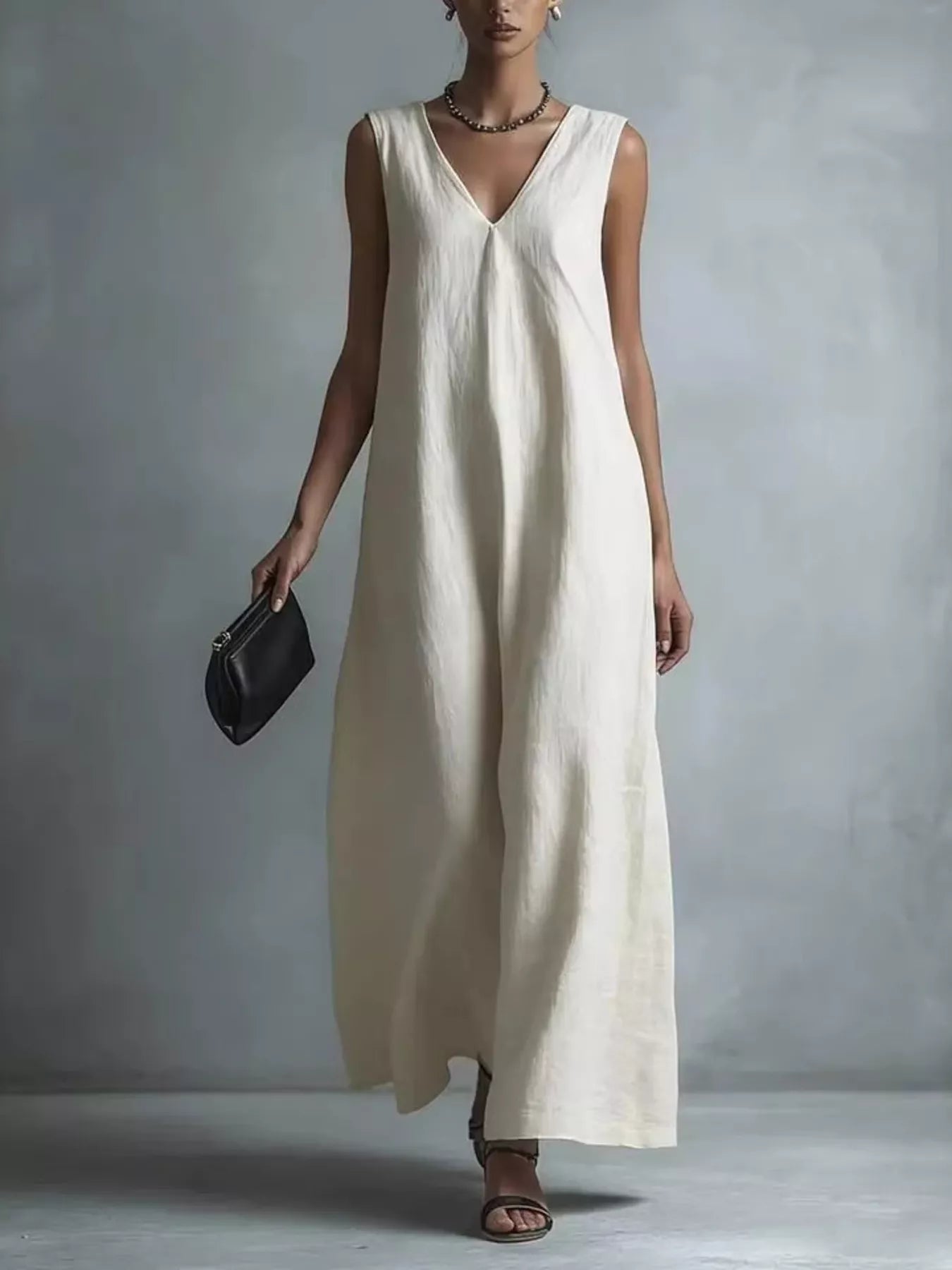 NEWYORKLISTED STYLE COLLECTION: Woman wearing a long white dress against a plain background