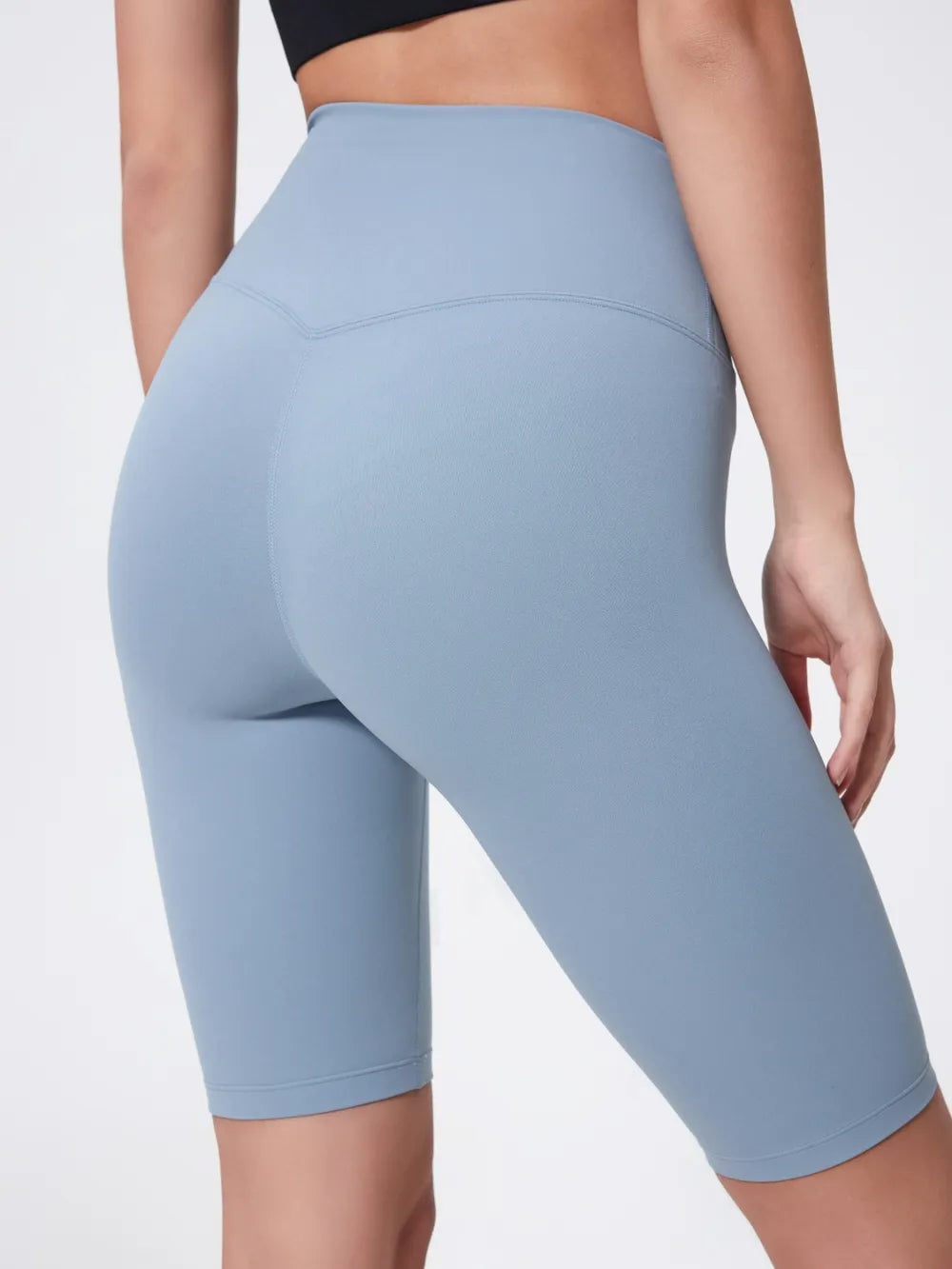 Light blue athletic shorts worn by a person on a plain background