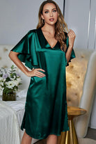 NEWYORKLISTED Intimate Apparel: Woman wearing a green satin dress in a bedroom setting