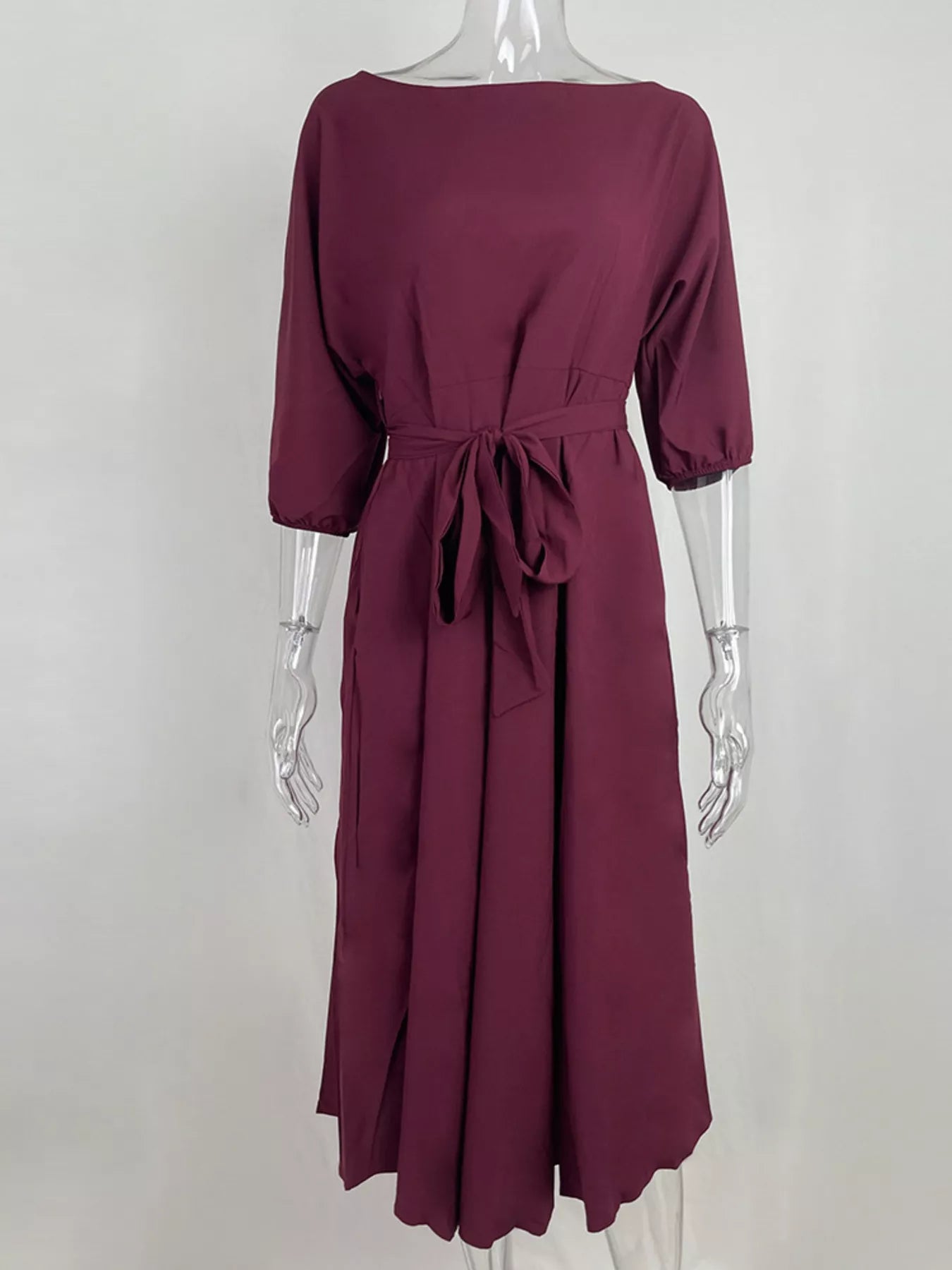 NEWYORKLISTED STYLE COLLECTION: Maroon dress on a mannequin against a white background