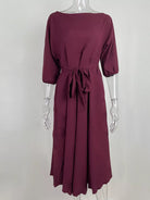 NEWYORKLISTED STYLE COLLECTION: Maroon dress on a mannequin against a white background