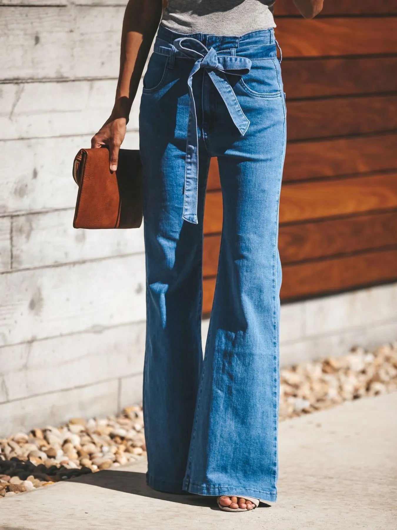High-Waisted Tie-Front Flare Jeans from the NEWYORKLISTED STYLE COLLECTION. Waist-slimming bow detail, premium stretch denim, and elongated flare silhouette. Shop luxury-inspired fashion at NEWYORKLISTED.COM