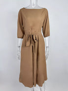 NEWYORKLISTED STYLE COLLECTION: Brown dress on a mannequin against a white background