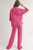 NEWYORKLISTED Comfort Collection: Person wearing a pink checkered pajama set on a plain background