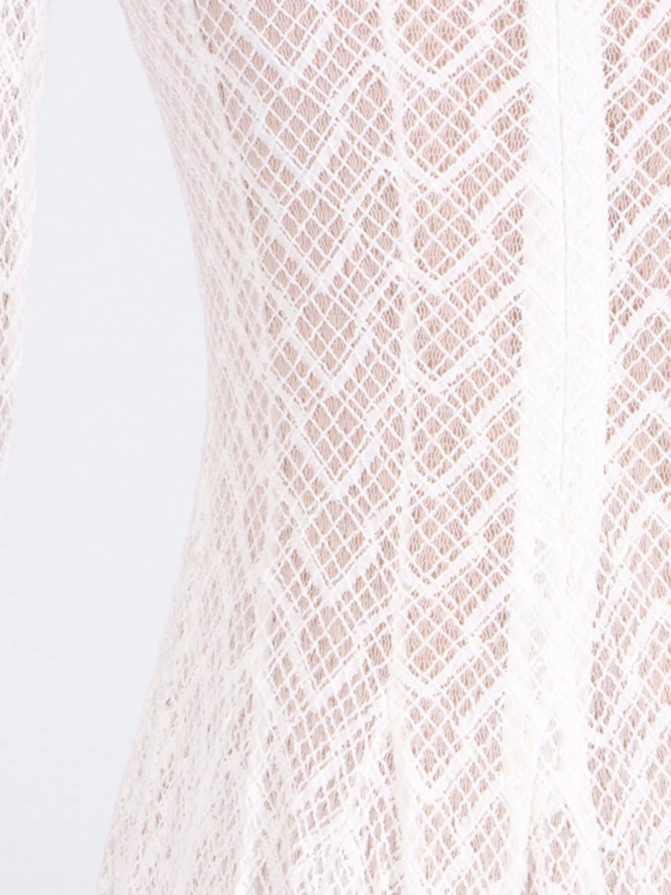 NEWYORKLISTED STYLE COLLECTION: Close-up of a textured fabric with a diamond pattern on a light background