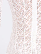 NEWYORKLISTED STYLE COLLECTION: Close-up of a textured fabric with a diamond pattern on a light background