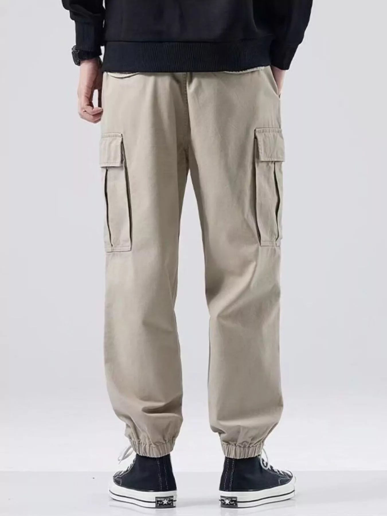 NEWYORKLISTED ATLAS MEN'S COLLECTION: Beige cargo pants worn by a person on a white background