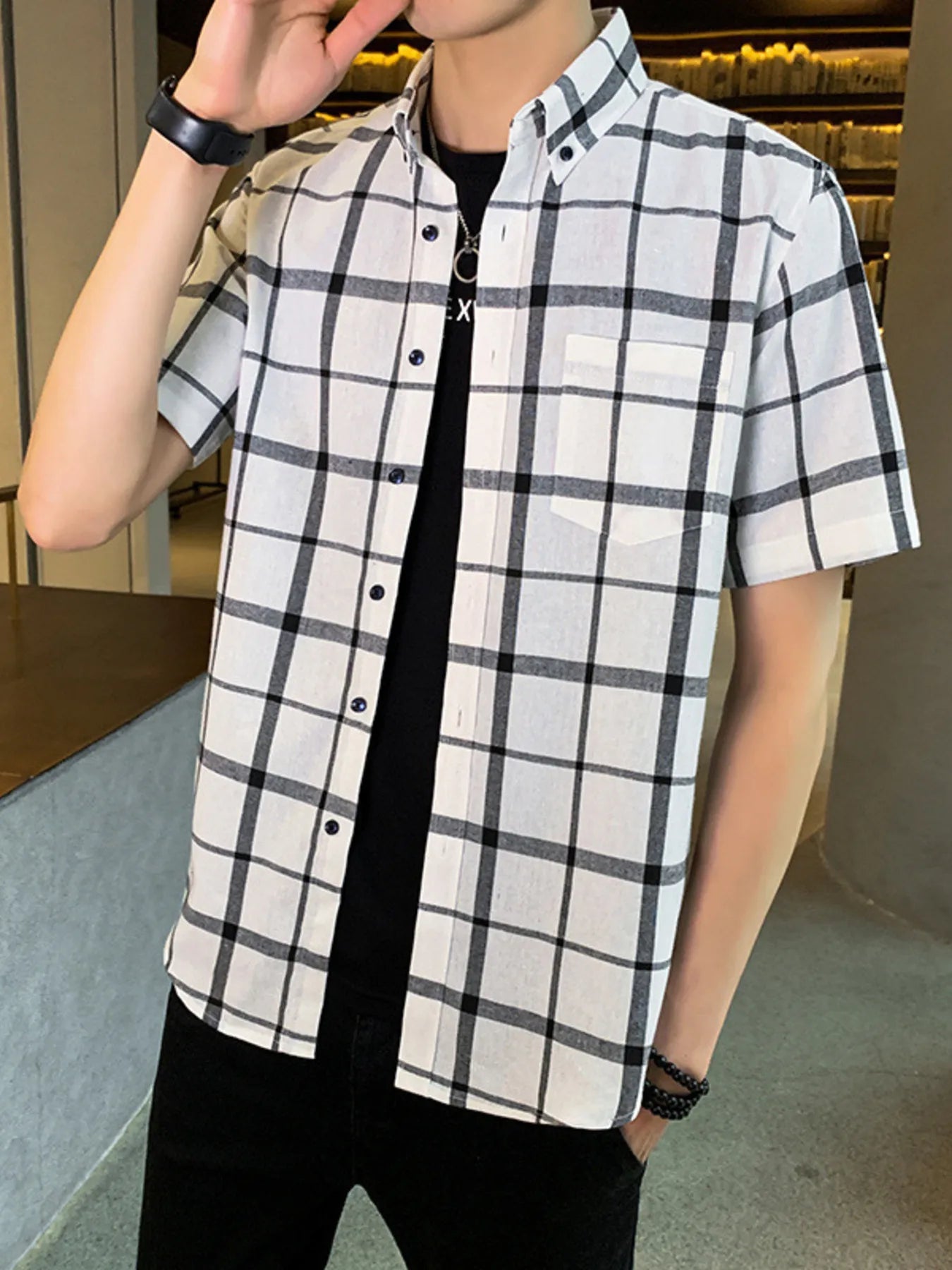 NEWYORKLISTED ATLAS MEN'S COLLECTION: Person wearing a black and white checkered shirt with a blurred indoor background