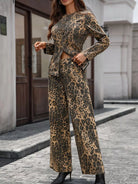 NEWYORKLISTED STYLE COLLECTION: Woman wearing a leopard print outfit standing on a street.