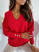 NEWYORKLISTED STYLE COLLECTION: Red blouse with gold buttons worn by a person, blurred background